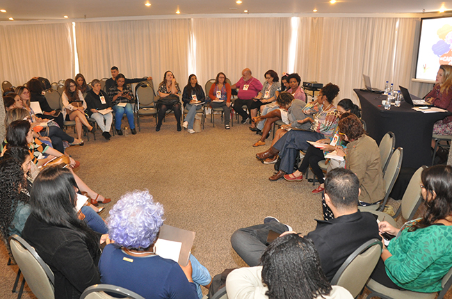 Imagem mostra auditório com cadeiras organizadas em círculo para os debates em grupos