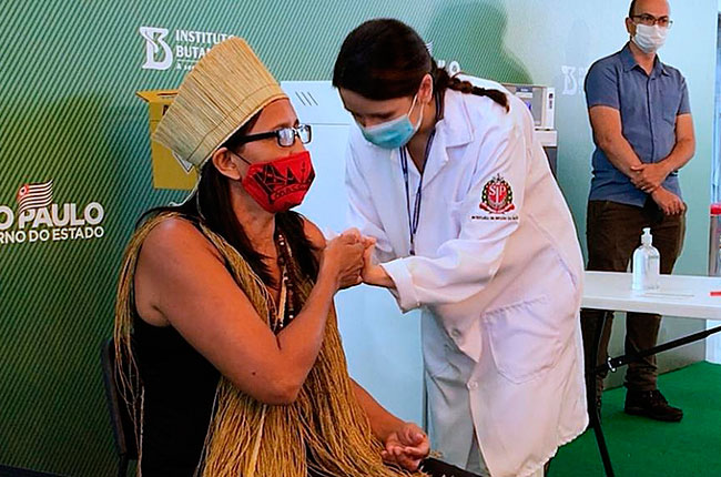 Imagem da indígena Vanuza Kaimbé no momento em que tomou a vacina contra a covid-19.