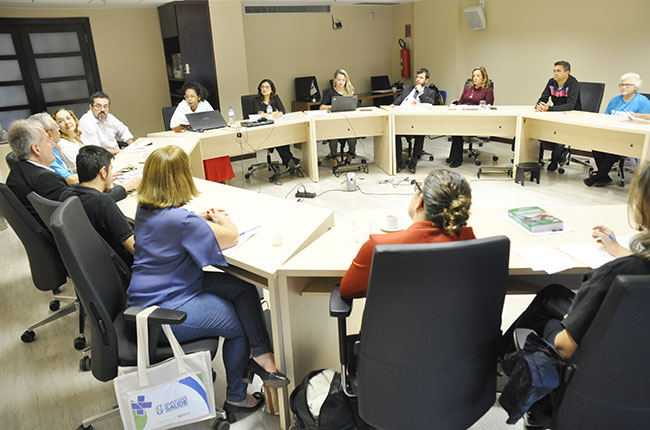 Imagem de representantes das entidades em círculo durante o debate na sede do CFESS.